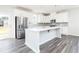 Modern kitchen with a large island, stainless steel appliances, and stylish gray wood flooring at 2715 Stream Valley Lane Nw Nw Cir, Atlanta, GA 30318