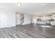 Spacious living room leading to the kitchen with gray wood flooring and a staircase at 2715 Stream Valley Lane Nw Nw Cir, Atlanta, GA 30318