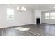 Bright living room featuring a fireplace, large windows, and stylish gray wood flooring at 2715 Stream Valley Lane Nw Nw Cir, Atlanta, GA 30318