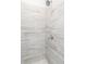 Close-up of a tiled shower with gray marble-style tiles and sleek fixtures, offering a modern aesthetic at 2715 Stream Valley Lane Nw Nw Cir, Atlanta, GA 30318