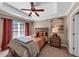 Cozy bedroom with tray ceiling, ceiling fan, and natural light from a window at 805 Pleasant Hill Nw Rd # 343, Lilburn, GA 30047