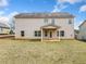 View of backyard with covered porch, showing the house's siding and a glimpse of the grassy lawn at 9109 Alden Dr, Locust Grove, GA 30248