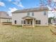 Backyard features the home's siding, windows, covered porch, and green lawn under a partly cloudy sky at 9109 Alden Dr, Locust Grove, GA 30248
