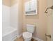 Bathroom featuring a white toilet, bathtub and cabinet with nickel hardware at 9109 Alden Dr, Locust Grove, GA 30248