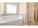 Relax in this cozy bathroom with a soaking tub and separate shower at 9109 Alden Dr, Locust Grove, GA 30248