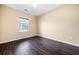 This bedroom offers ample natural light, hardwood flooring, and neutral walls at 9109 Alden Dr, Locust Grove, GA 30248