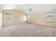 Spacious bedroom with neutral carpet, vaulted ceiling, and multiple windows for natural light at 9109 Alden Dr, Locust Grove, GA 30248