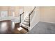 Open entryway has hardwood floors, a staircase, and leads to the formal living area at 9109 Alden Dr, Locust Grove, GA 30248