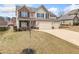 Charming two-story home with a brick facade and a spacious driveway leading to a two-car garage at 9109 Alden Dr, Locust Grove, GA 30248