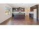 Open kitchen with dark cabinets, granite countertops, and a center island at 9109 Alden Dr, Locust Grove, GA 30248
