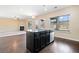 Kitchen island featuring pendant lighting, stainless steel appliances, and open to the living area at 9109 Alden Dr, Locust Grove, GA 30248