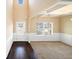 Bright, high ceilinged living room with dark hardwood floors and a large window at 9109 Alden Dr, Locust Grove, GA 30248