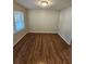 Cozy bedroom featuring hardwood floors, neutral paint, and a window providing natural light at 2681 Aquamist Dr, Decatur, GA 30034