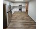 Well-equipped kitchen with stainless steel appliances, light gray granite countertops, and luxury vinyl plank flooring at 2681 Aquamist Dr, Decatur, GA 30034