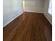 Spacious living room featuring gleaming hardwood floors, neutral paint, and abundant natural light from a window at 2681 Aquamist Dr, Decatur, GA 30034