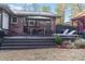 Outdoor dining area with modern patio furniture on wooden deck and landscaped yard at 3504 Palace Ct, Tucker, GA 30084