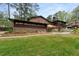 Well-maintained backyard with lush lawn, beautiful landscaping, and multiple outdoor seating areas at 3504 Palace Ct, Tucker, GA 30084