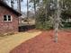 View of landscaped side yard featuring a fence and mature trees providing privacy at 3504 Palace Ct, Tucker, GA 30084
