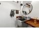 Stylish powder room features a stainless steel sink, butcher block countertop, and round mirror at 3504 Palace Ct, Tucker, GA 30084