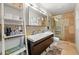 Well lit bathroom with double vanity, mosaic tile accent wall, walk-in shower, and modern fixtures at 3504 Palace Ct, Tucker, GA 30084