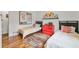 Charming bedroom with two twin beds, a colorful area rug, and fun art above the red dresser at 3504 Palace Ct, Tucker, GA 30084