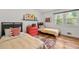 Bright bedroom featuring two twin beds, hardwood floors, a red dresser, and large windows for plenty of natural light at 3504 Palace Ct, Tucker, GA 30084