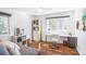 Bright bedroom featuring hardwood floors, a modern desk, and ample natural light from the large window at 3504 Palace Ct, Tucker, GA 30084