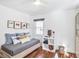 Bright bedroom with a daybed, hardwood floors, and natural light from a large window at 3504 Palace Ct, Tucker, GA 30084