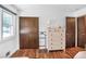 Bedroom with hardwood floors, closet, and neutral-toned dresser under a bright window at 3504 Palace Ct, Tucker, GA 30084