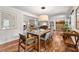 Open concept dining room with hardwood floors and modern light fixture at 3504 Palace Ct, Tucker, GA 30084