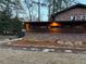 Exterior view of a brick home with a modern addition, stone walkway, and professional landscaping at 3504 Palace Ct, Tucker, GA 30084