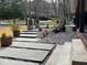 Concrete steps leading up to the porch of a brick home with manicured rock garden at 3504 Palace Ct, Tucker, GA 30084