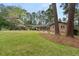 Sprawling front yard view of brick home with mature trees and meticulously maintained lawn at 3504 Palace Ct, Tucker, GA 30084