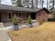 Brick ranch home with concrete walkway leading to the front door, featuring a manicured rock garden at 3504 Palace Ct, Tucker, GA 30084