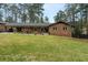 Charming brick ranch home with a well-manicured lawn and covered carport at 3504 Palace Ct, Tucker, GA 30084