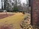Exterior of the red brick home featuring a nicely landscaped rock garden at 3504 Palace Ct, Tucker, GA 30084