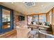 Cozy sunroom with brick accent wall, hardwood flooring, and comfortable seating at 3504 Palace Ct, Tucker, GA 30084