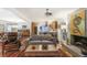 Open concept living room with a fireplace and hardwood floors, flowing into the kitchen and dining areas at 3504 Palace Ct, Tucker, GA 30084