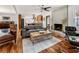 Open living room with hardwood floors, a fireplace, and views into the kitchen at 3504 Palace Ct, Tucker, GA 30084
