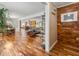 Open concept living space with hardwood floors and a wood paneled accent wall at 3504 Palace Ct, Tucker, GA 30084