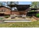 Inviting backyard patio with a fire pit, comfortable seating, and manicured landscaping at 3504 Palace Ct, Tucker, GA 30084