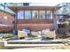 Backyard brick patio with modern furniture and a sleek, round fire pit at 3504 Palace Ct, Tucker, GA 30084