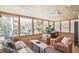 Bright sunroom with natural light, comfortable seating, and views of lush greenery at 3504 Palace Ct, Tucker, GA 30084