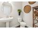 Clean powder room with a pedestal sink and decorative accents at 109 Bridlington St, Sugar Hill, GA 30518