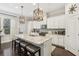 Bright kitchen with white cabinets, granite countertops, and island seating at 109 Bridlington St, Sugar Hill, GA 30518