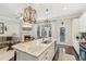 Open concept kitchen flows into the living area with island and fireplace at 109 Bridlington St, Sugar Hill, GA 30518