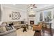 Cozy living room features a fireplace, ceiling fan, and comfortable seating at 109 Bridlington St, Sugar Hill, GA 30518