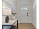 Bright foyer featuring hardwood floors, a stylish console table, and a modern light fixture at 2083 Fairhaven Ne Cir, Atlanta, GA 30305