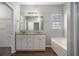Bathroom featuring double sinks, granite countertops, and a separate tub and shower at 441 Concord Cir, Mcdonough, GA 30253