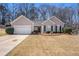 Charming single-story home with a well-manicured lawn and an attached two-car garage at 441 Concord Cir, Mcdonough, GA 30253